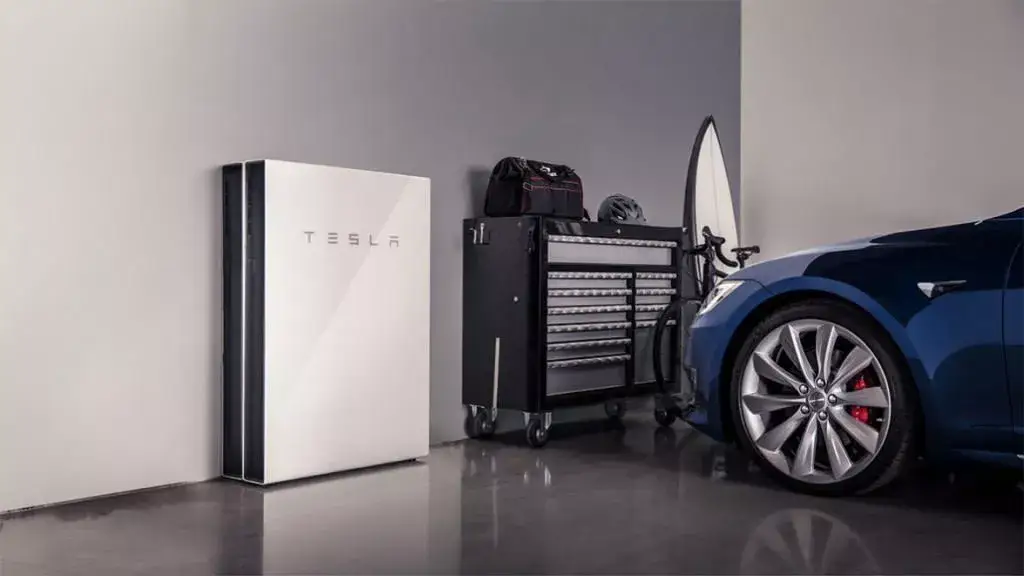 Tesla Powerwall mounted on a wall in a garage