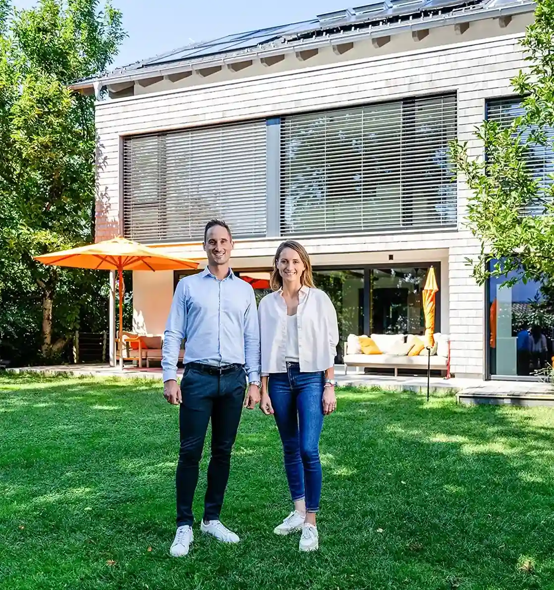 Clientes satisfechos delante de su instalación fotovoltaica en su casa