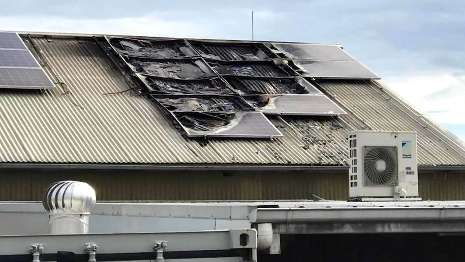 Damaged solar panels on a corrugated roof
