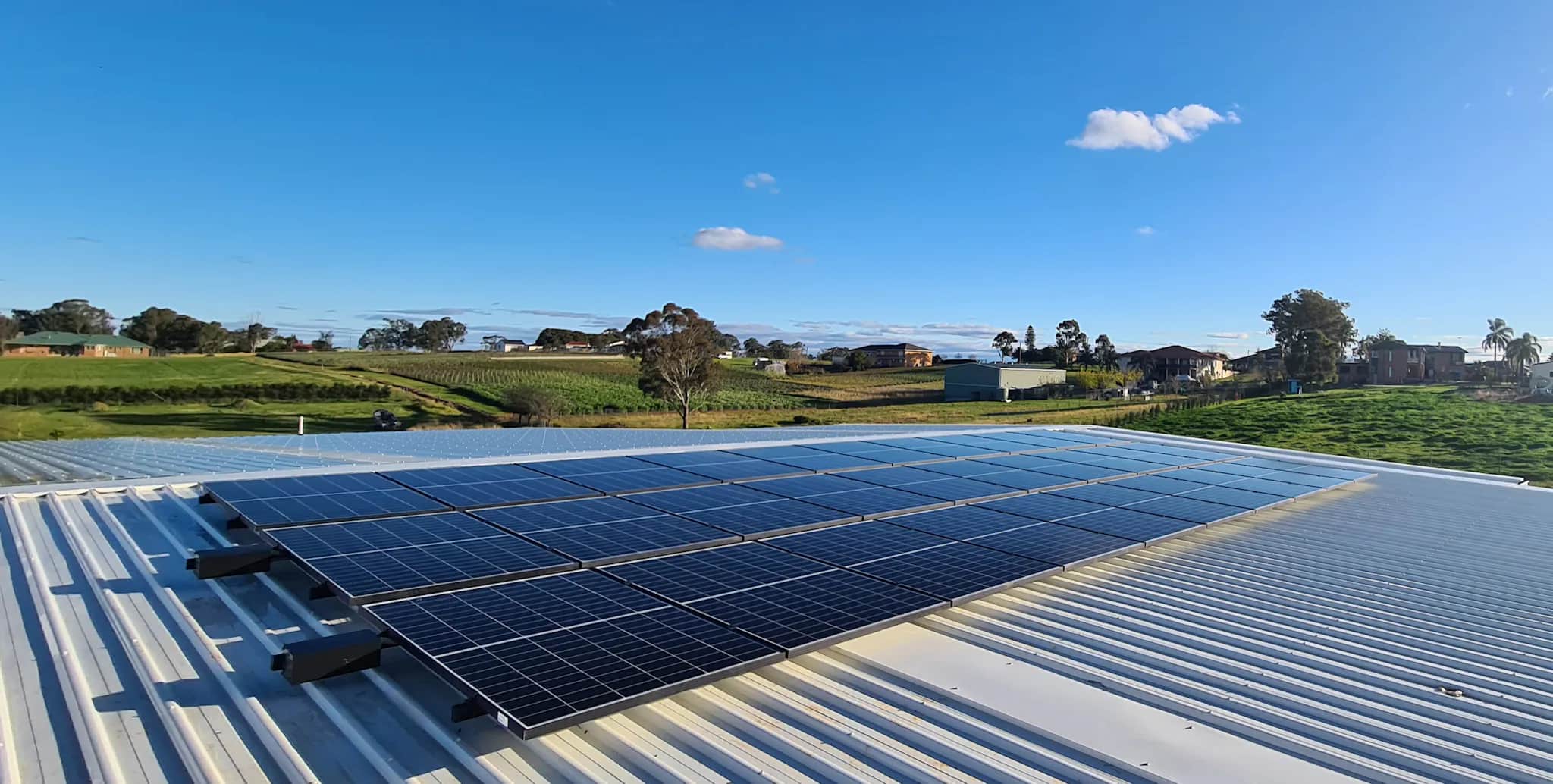 solar on roof with farm on the background