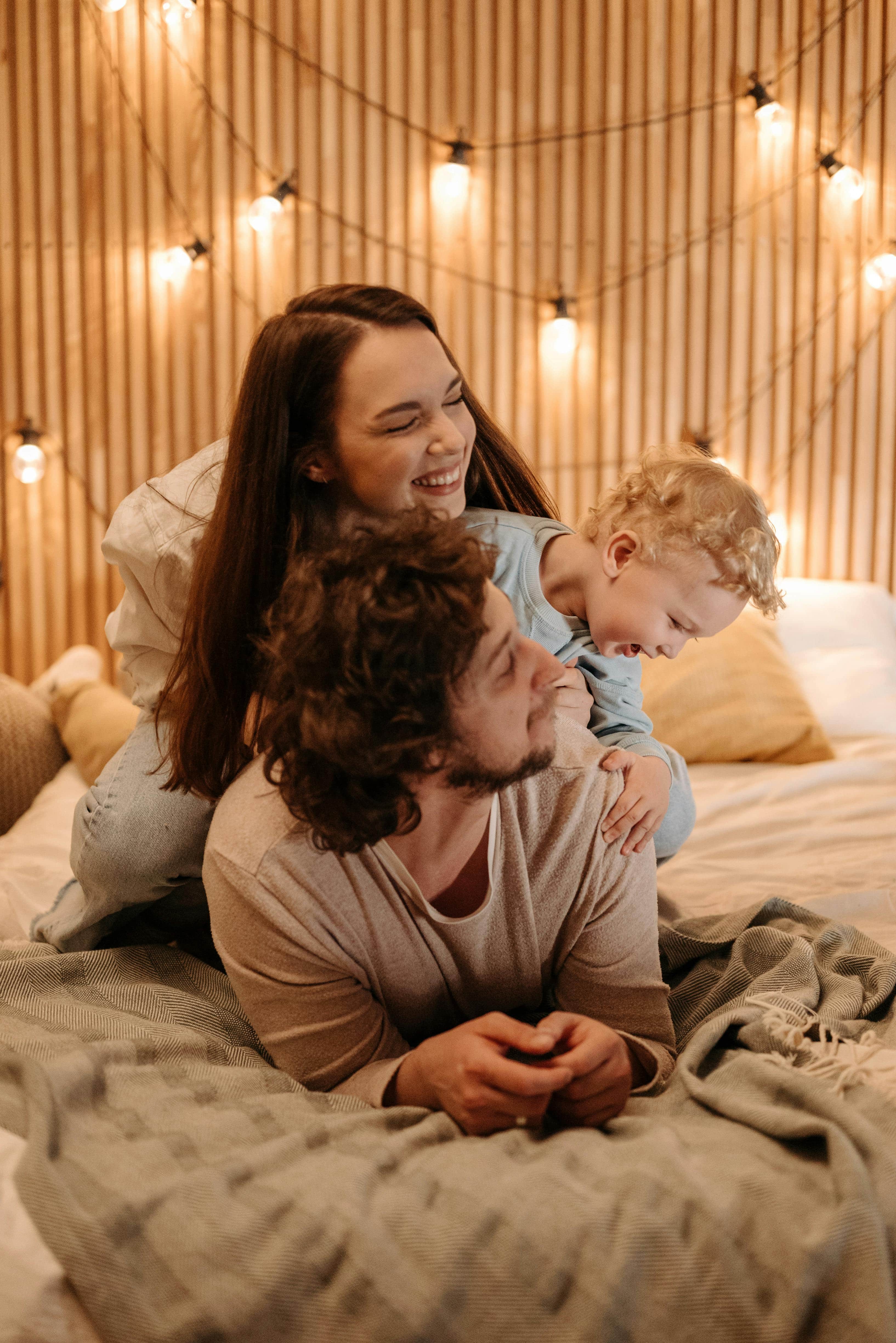 happy family lying in bed