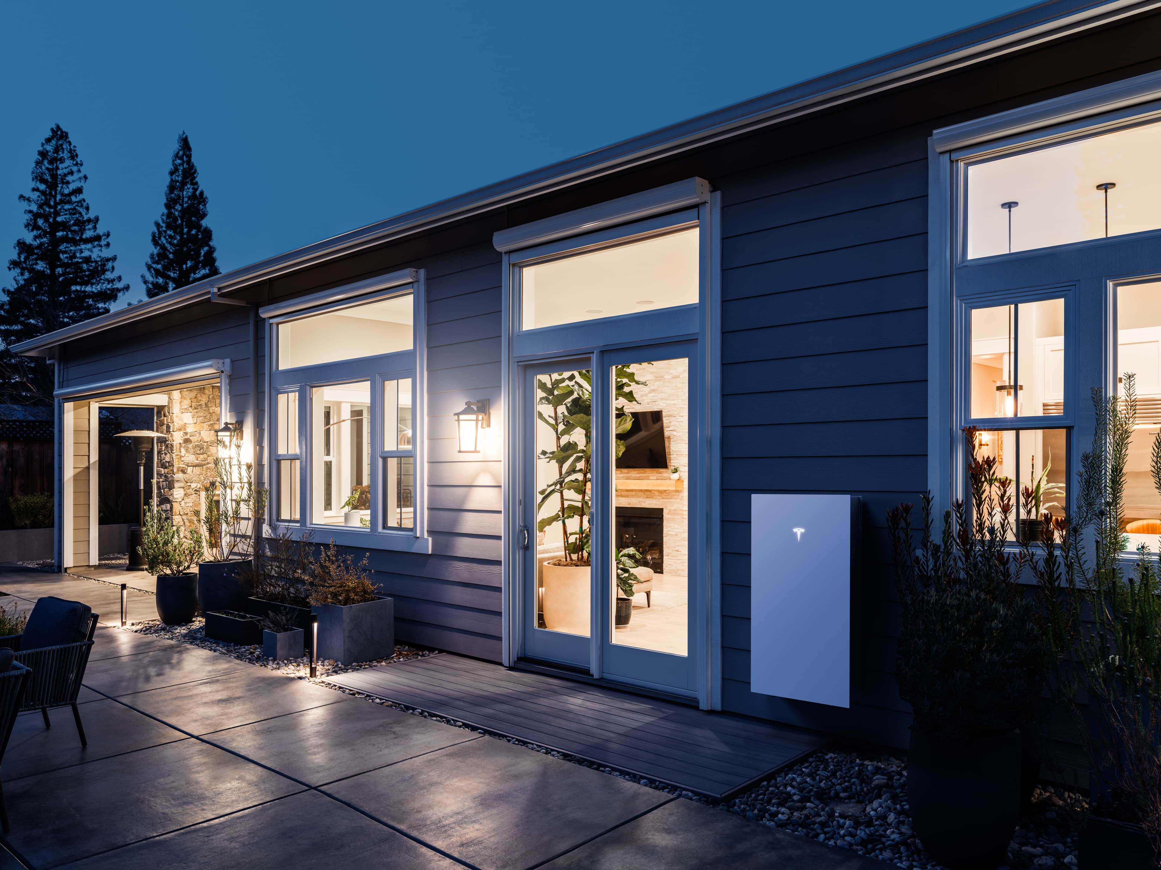 Tesla Powerwall 3 Mounted on the Wall Outside a Home