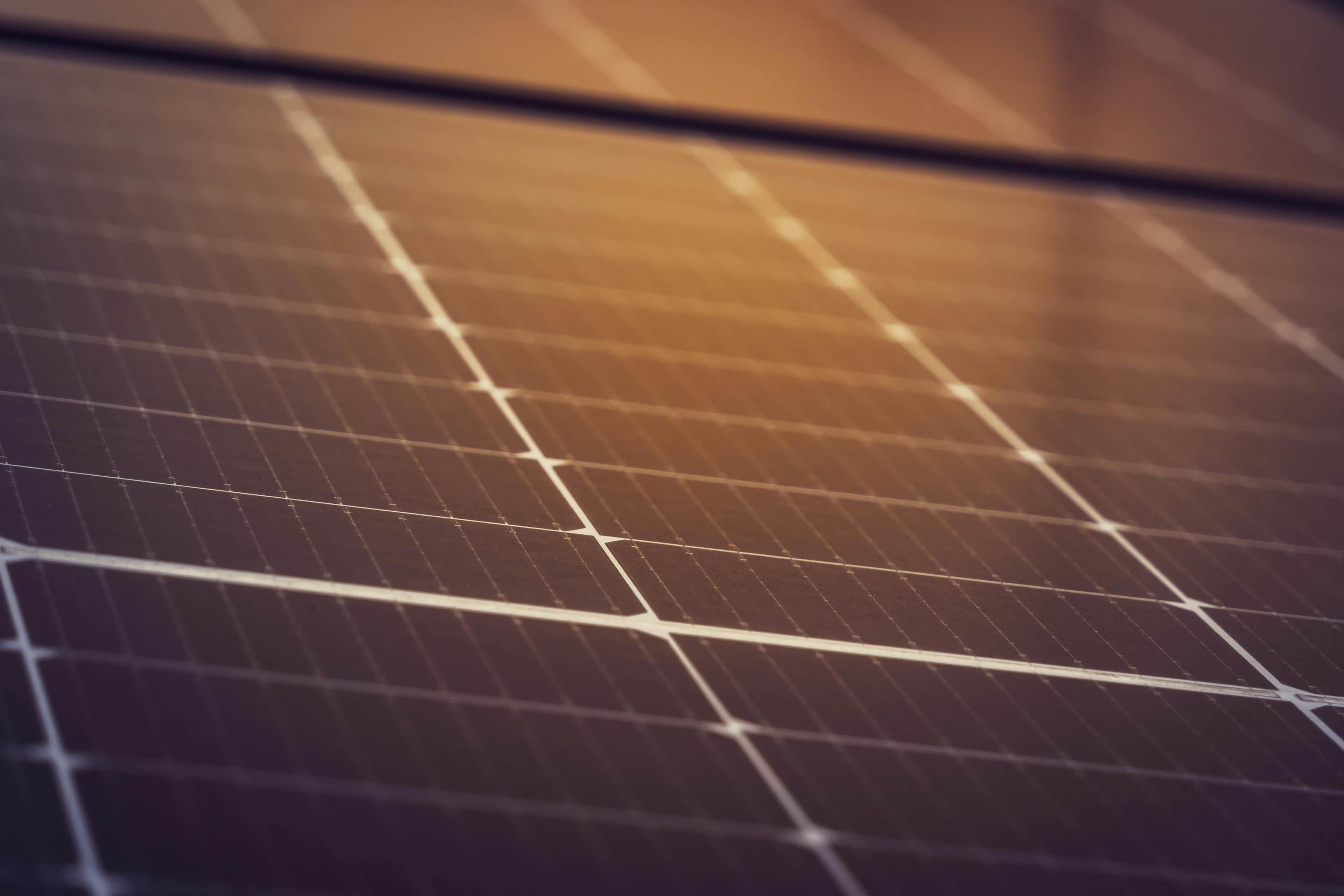 Close-up view of solar panels with sunlight reflecting