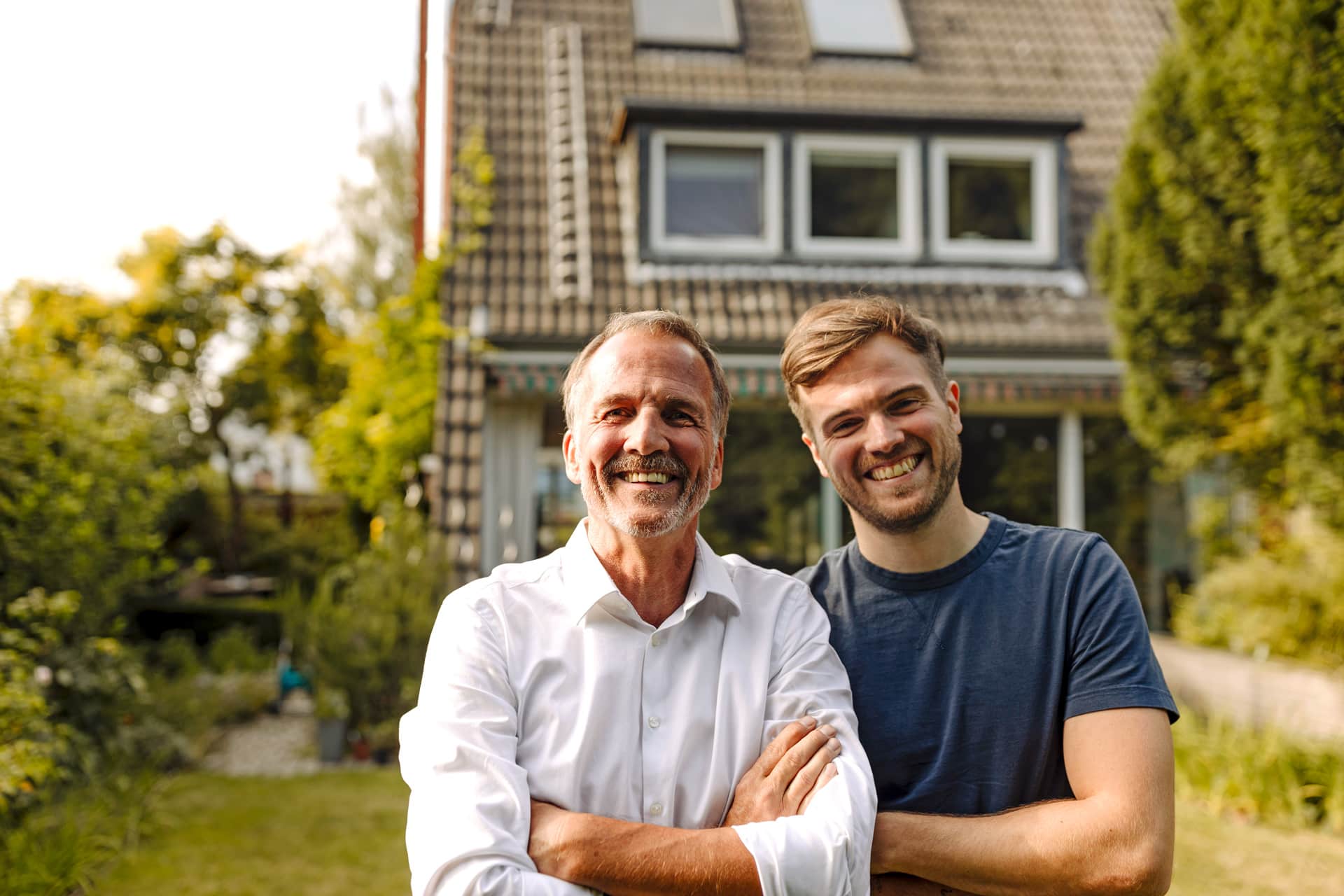 two men outside house