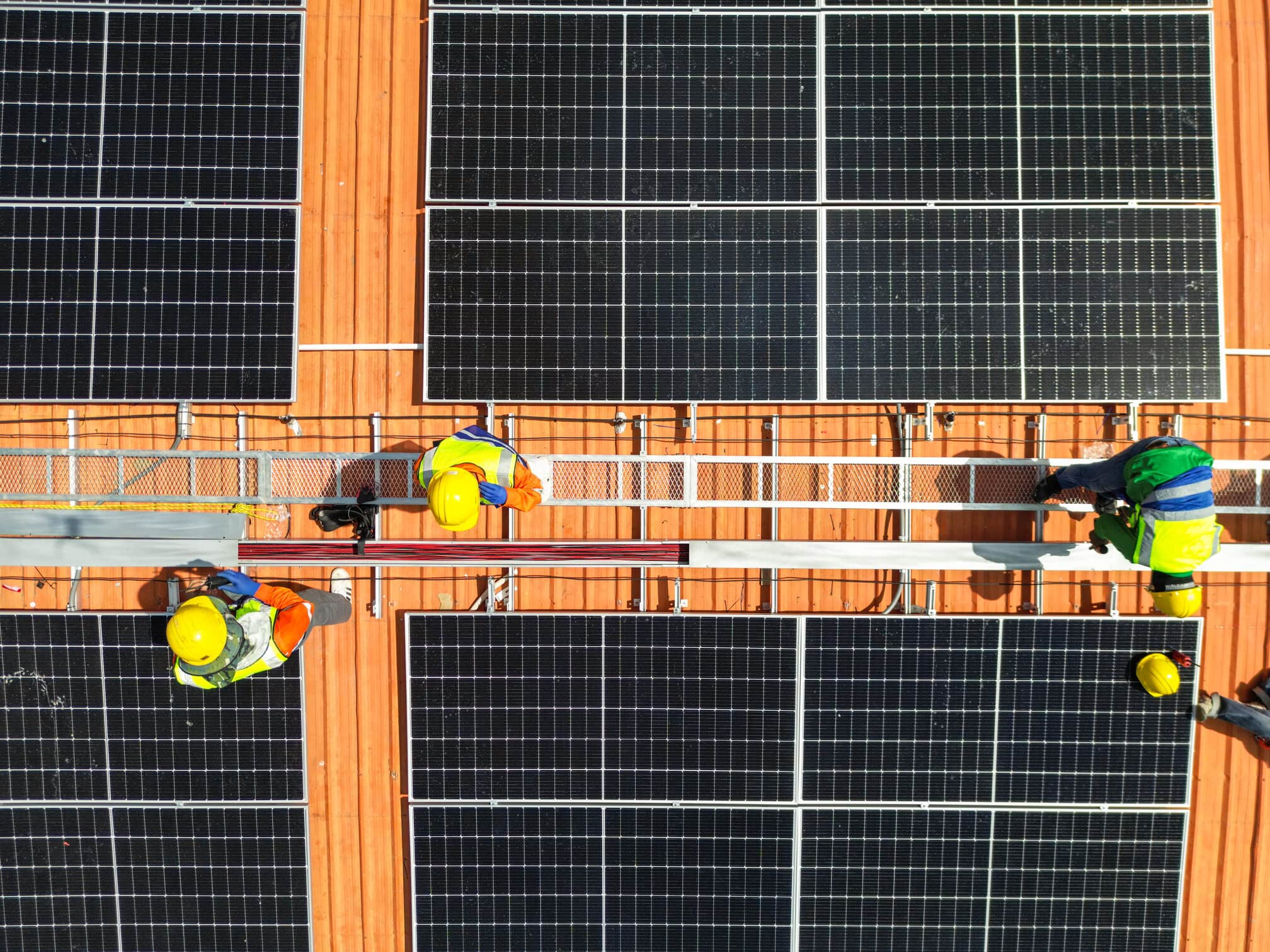 engineer checking on wires of solar panels