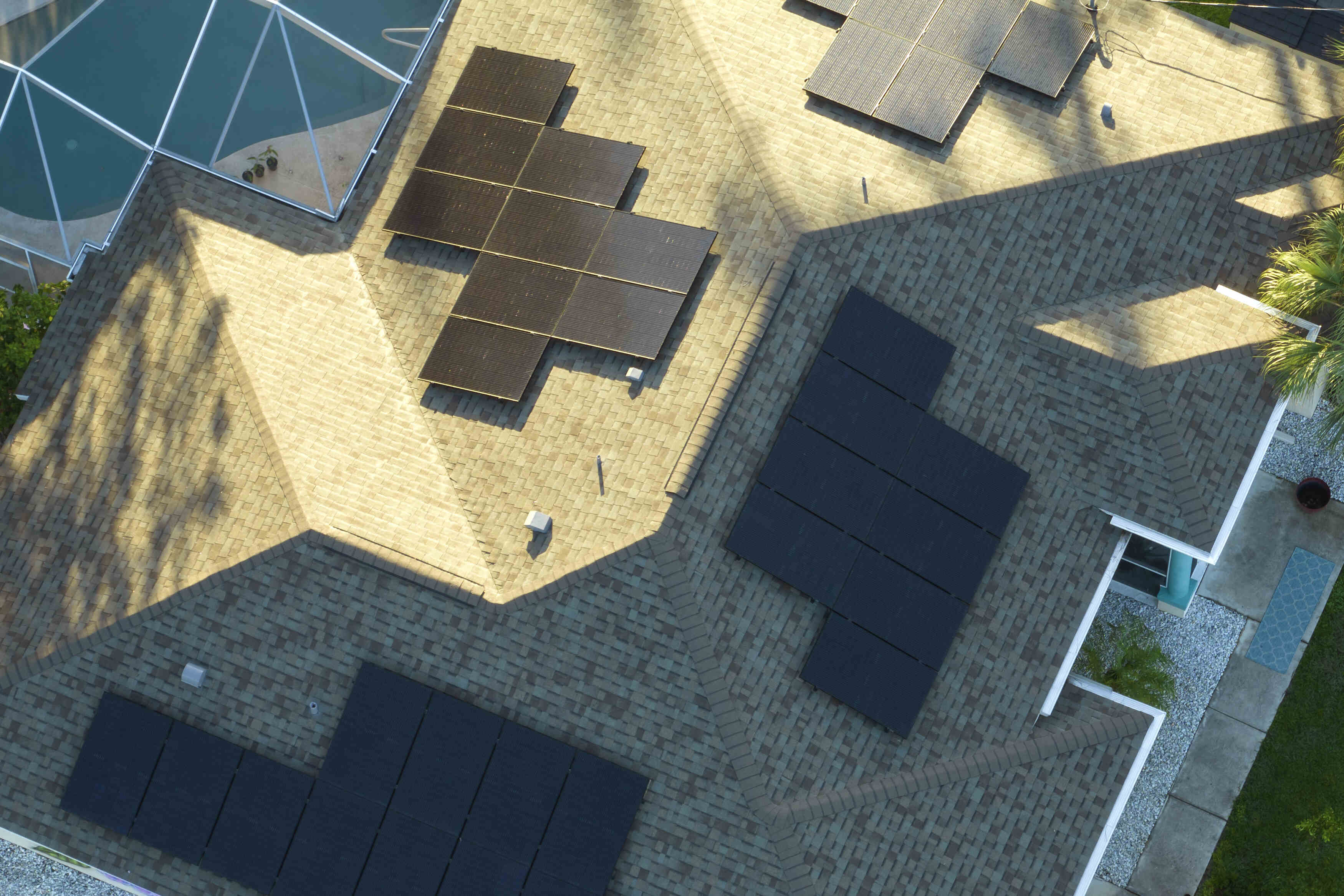 photo of solar panels on a roof with half under a shade
