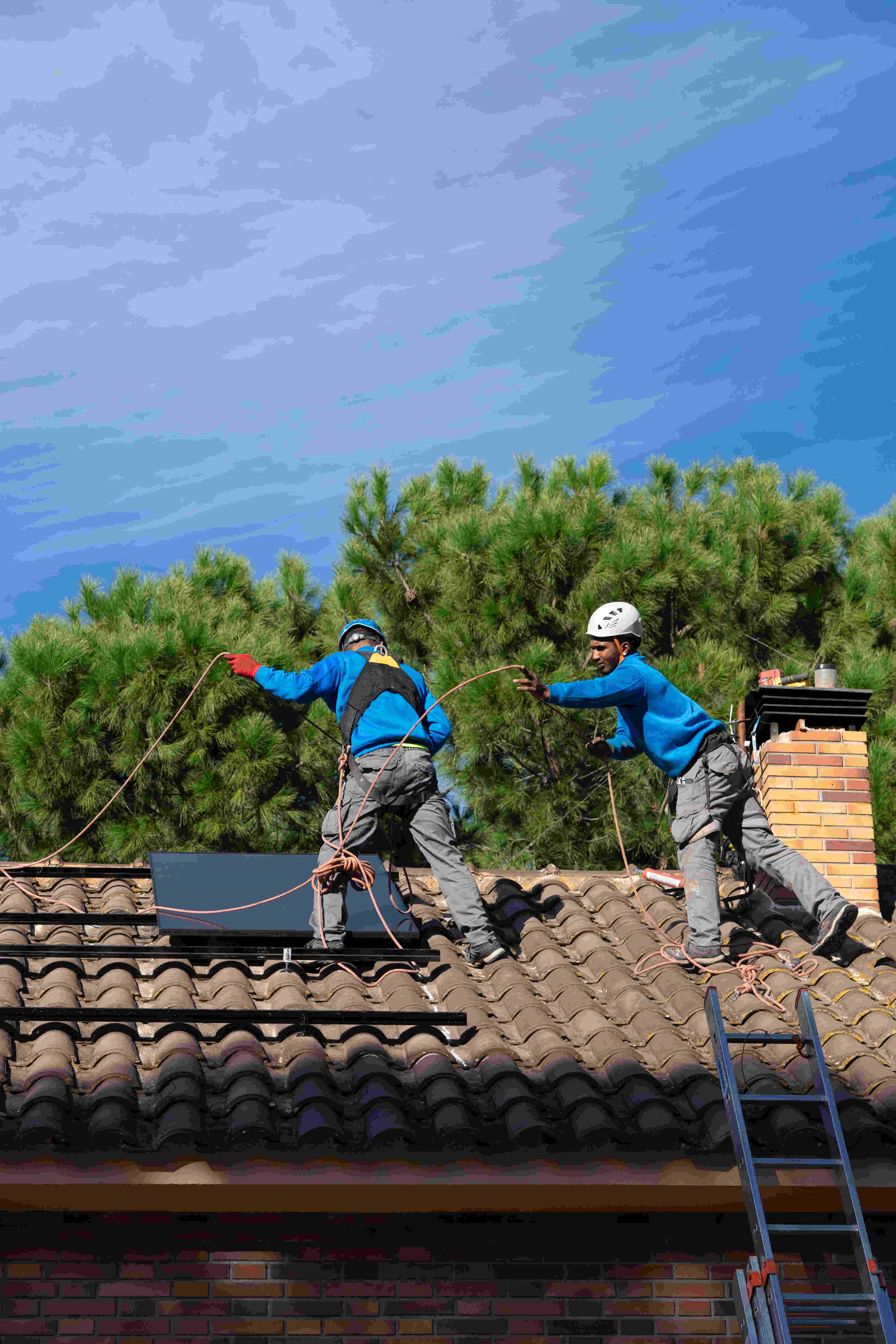 solar installers on a roof
