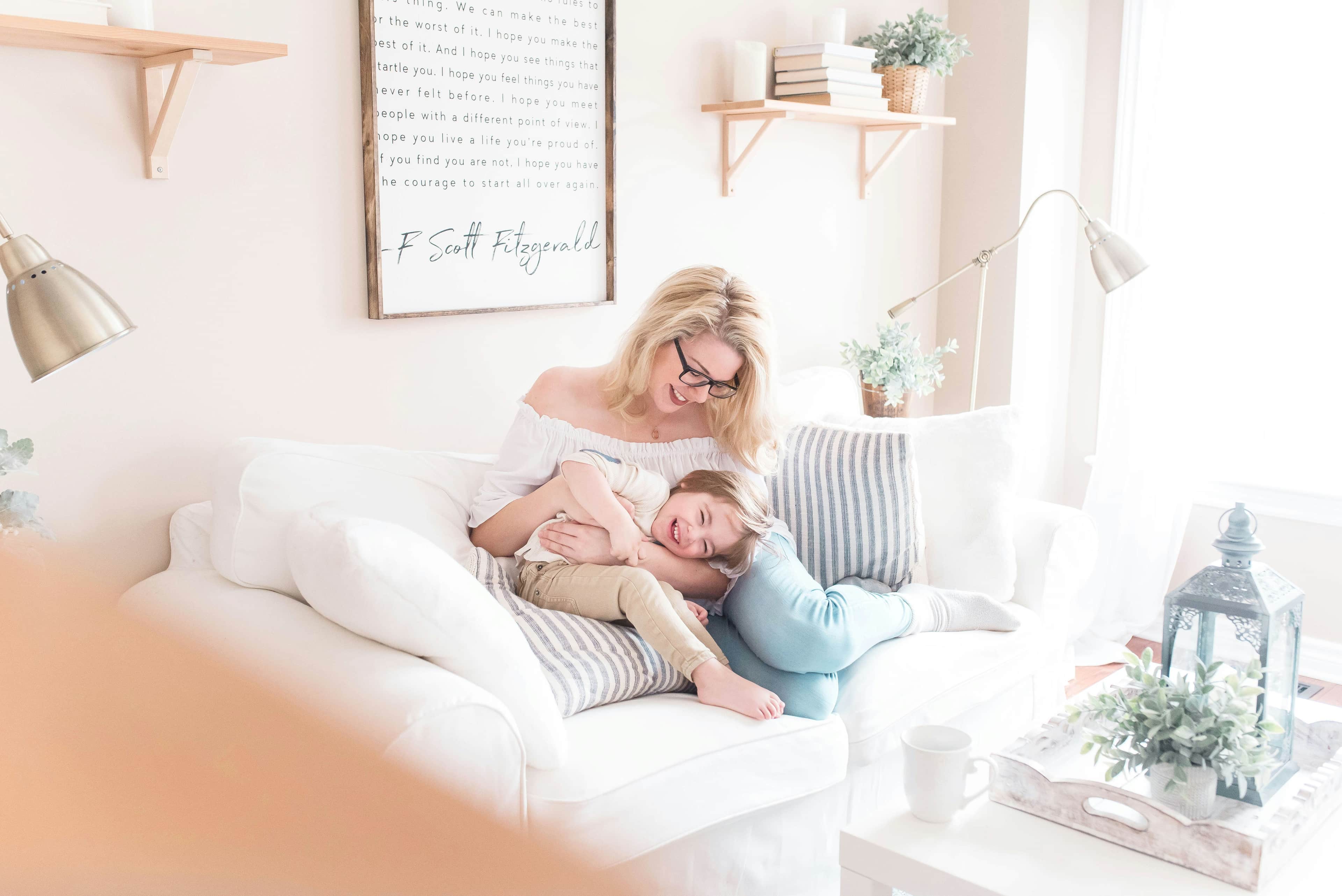 mother and daughter sitting on a couch in a living room