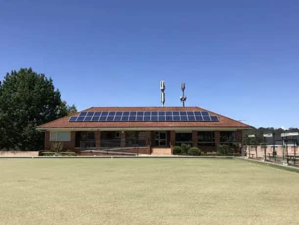 a single-story brick house with solar panels on the roof