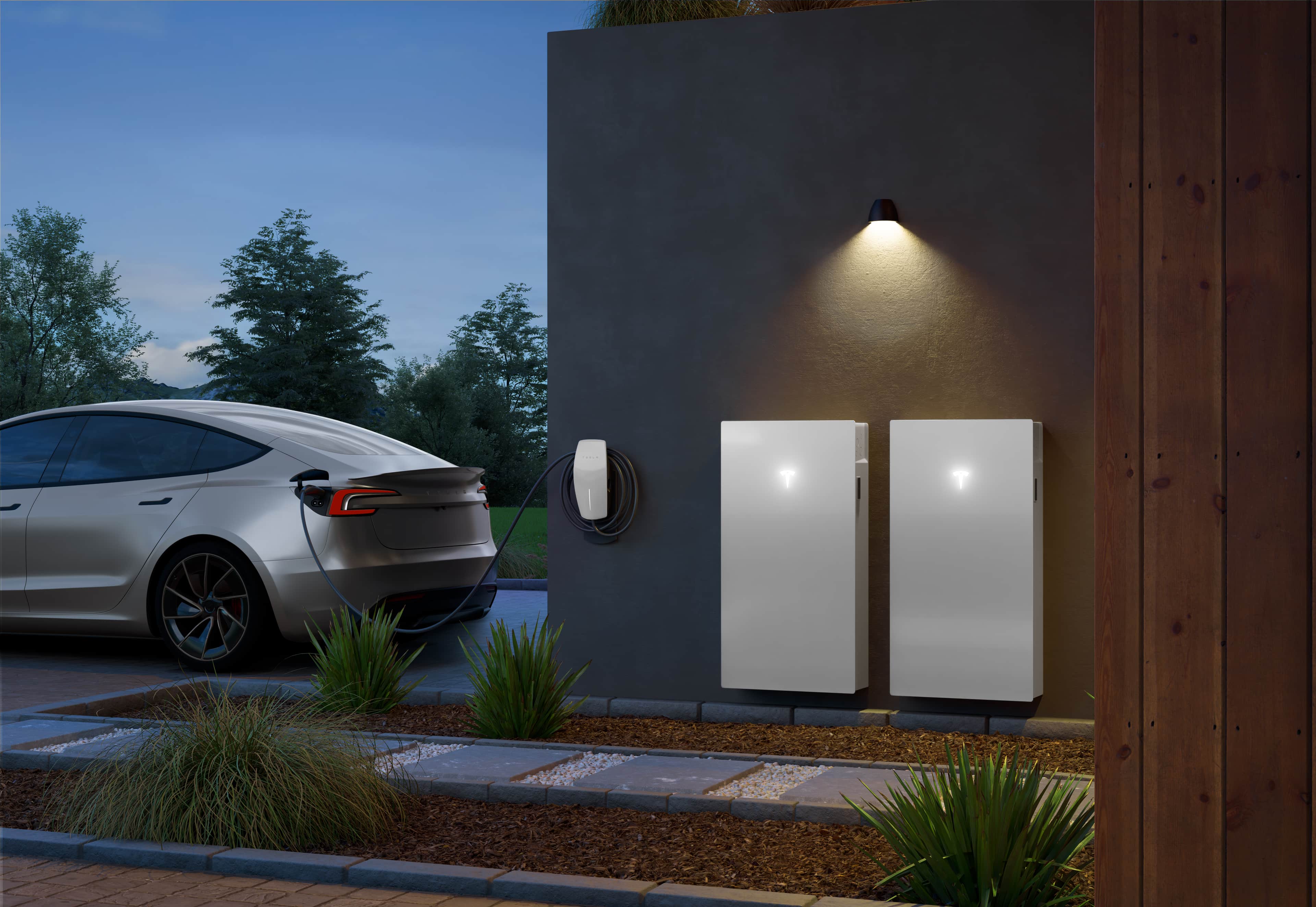 an electric car charges at home next to two Tesla Powerwall 3 units and a Tesla wall connector charging station