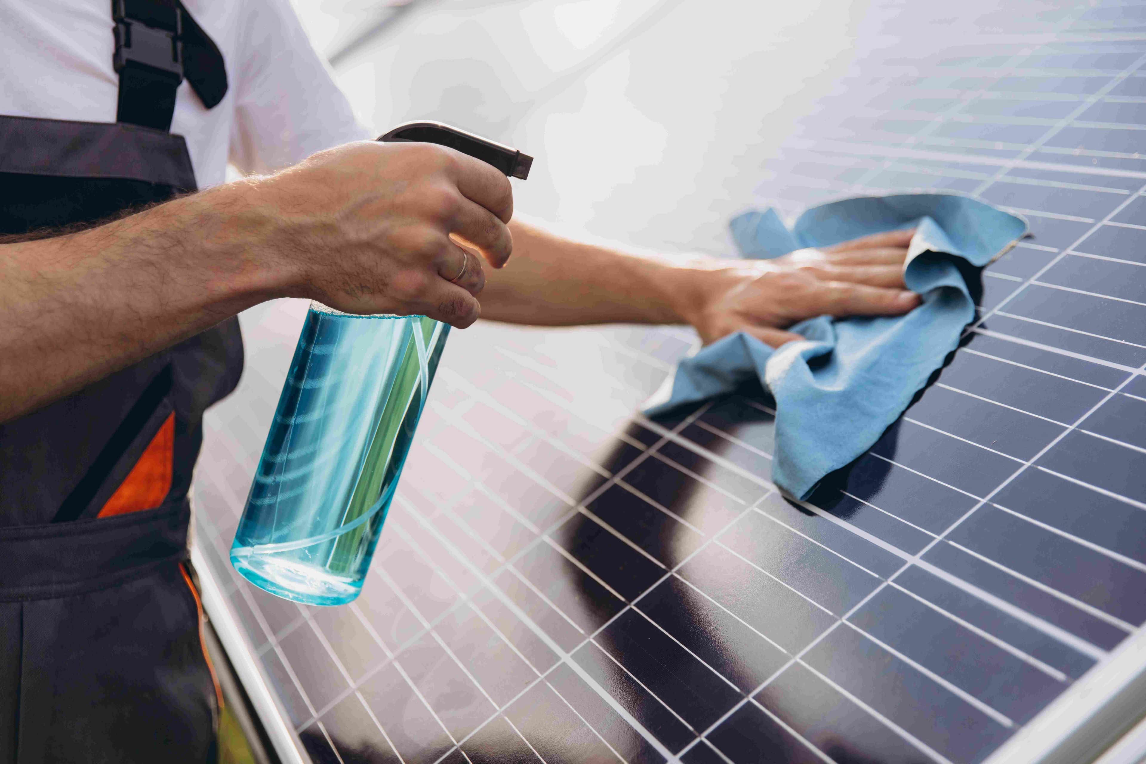 closeup of a worker cleaning solar panels